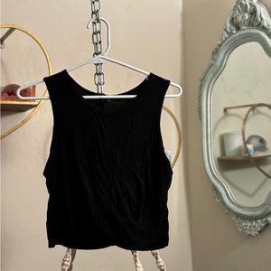 Women’s athletic, cropped tank top with flowy cris-cross.